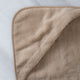 Baby hooded towel in color latte, detail shot from hood with marble background