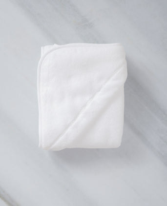 Baby Hooded Towel in white, detail shot from hood and DOUXE logo with marble background