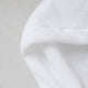 Baby hooded towel in white, detail shot from zero-twist cotton wit marble background